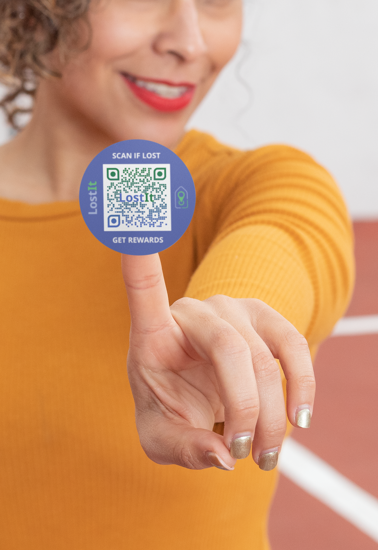 Mockup of a woman showing her round LostIt Tag sticker that can be applied to toys or any personal item that could get lost in public.